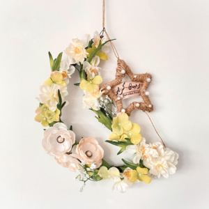 Floral wreath in crescent moon shape with star, reads Ramadan Kareem
